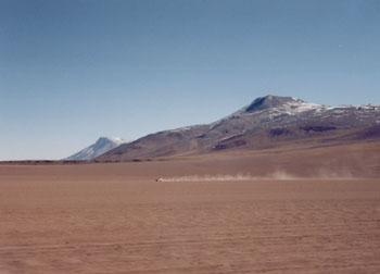 another vehicle cuts a dusty track across the desert, Bolivia