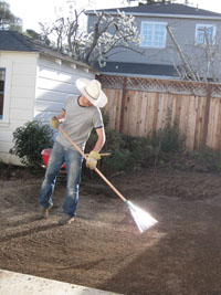 mike clears gravel from the yard